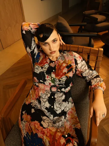 A relaxed yet chic pose in a modern setting. This type of shot is great for a lookbook, showing the outfit in a more natural, lifestyle context.
