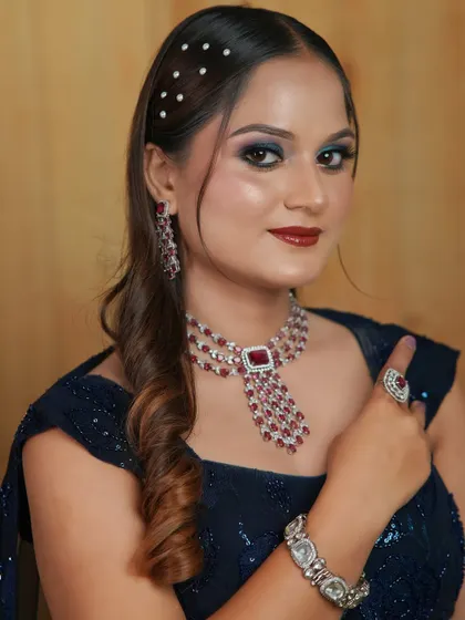 A confident pose showcasing the complete look, from the sparkling jewellery to the expertly applied makeup.