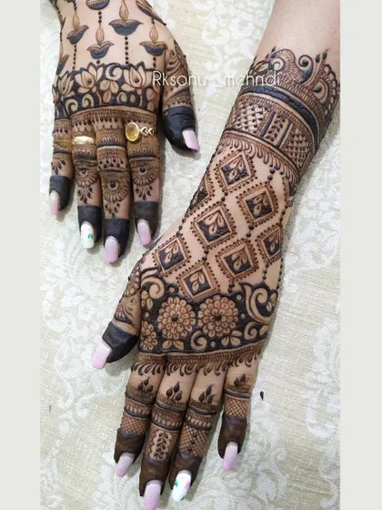 A playful and festive design featuring hanging diya lamps on one hand and a beautiful floral and geometric pattern on the other. This is a great choice for Diwali or other celebrations.