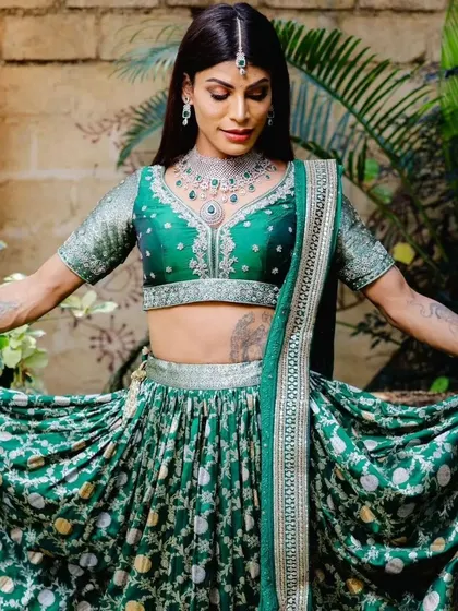 A full-length shot of the model, showing how our modern jewellery set complements the entire green lehenga ensemble.