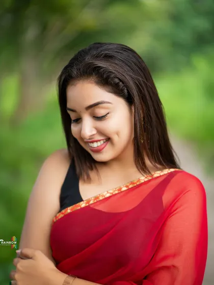 A shy, downward smile captured in a moment of candid grace. This portrait feels natural and unposed.
