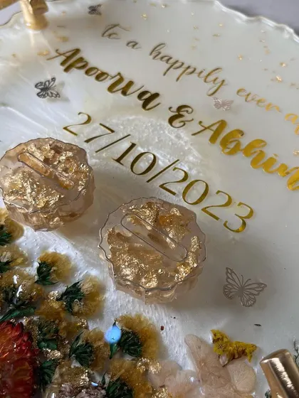 A close-up of a 3D floral look on a white resin tray. I used preserved flowers and crystals to create a beautiful, textured corner accent.