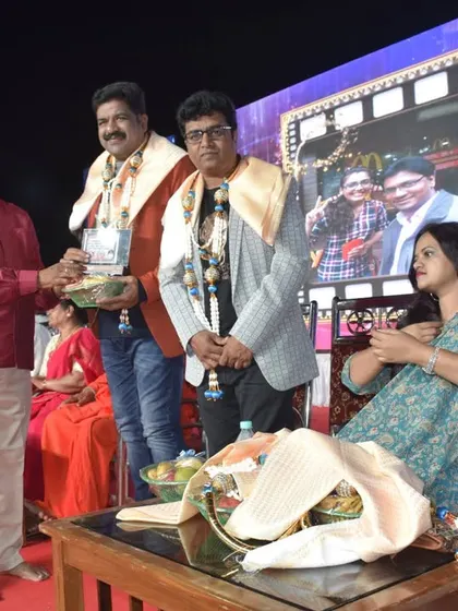 Being felicitated on stage during the RCN Channel 25th-anniversary program in Hunsur. I am grateful for the love from regional audiences.