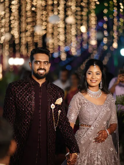 Raghavi and her partner at their reception. Her makeup is soft and pretty, complementing her delicate silver lehenga.
