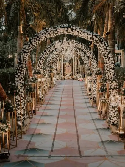 A grand floral archway tunnel for a reception, creating a spectacular walkway for guests.