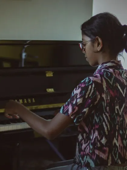 A student pianist performing with grace and focus. Our recitals are a testament to the hard work they put in.