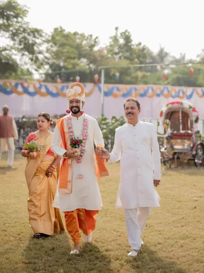 The groom's grand entrance with his parents, a proud and happy moment from a traditional Maharashtrian wedding.