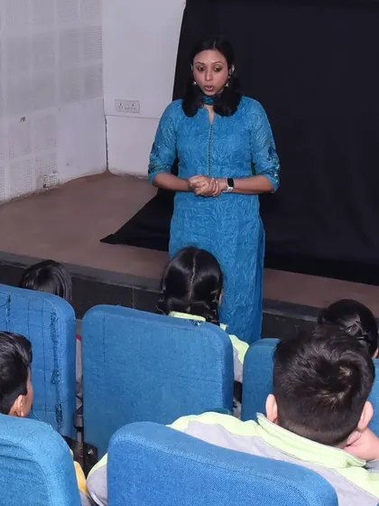 Here I am telling a story to an auditorium of students. I believe in connecting with the audience directly before the puppets appear to build trust and make them feel comfortable and ready for the adventure.