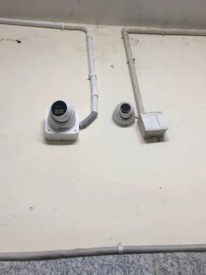 A clean installation of two dome cameras with neat wiring.