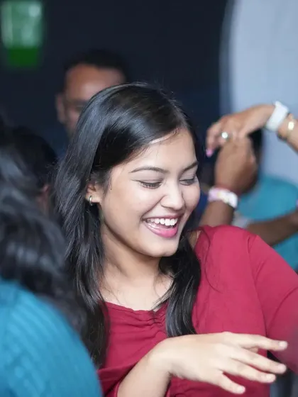 A guest with a huge smile, dancing with friends. The joy on the dance floor is contagious.