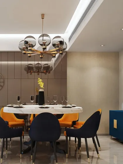 A bold and contemporary dining room with a mix of navy and orange chairs. The statement blue sideboard adds a pop of color and ample storage.