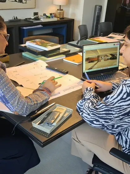 From plans on paper to visuals on screen, every project is a story of many minds at work. This image captures a moment of collaboration, where team members review architectural drawings and digital renders together to fine-tune every detail.