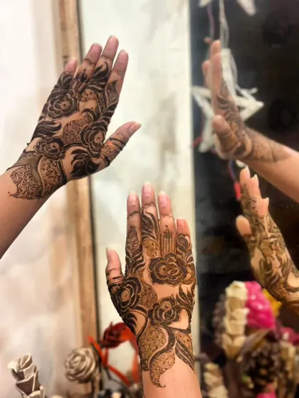 A creative shot using a mirror to reflect the bold rose design, showing it from multiple angles.