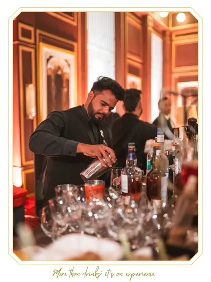 A moment of intense focus as our bartender crafts a drink. This image captures the precision and dedication that goes into every single cocktail we serve.