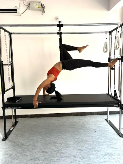 Another angle of the suspended bridge, showing the engagement of the glutes and hamstrings to maintain the pose.