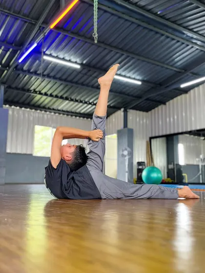 We believe flexibility is the foundation of functional strength. Here, a student demonstrates an advanced needle scale stretch, a result of consistent practice in our mobility and contortion sessions.