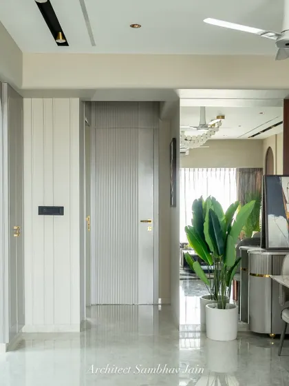 Framing calm in transit. This thoughtfully styled passageway turns a transitional space into a visual pause. A sleek mirror adds depth and light, while potted greens bring a refreshing burst of life.