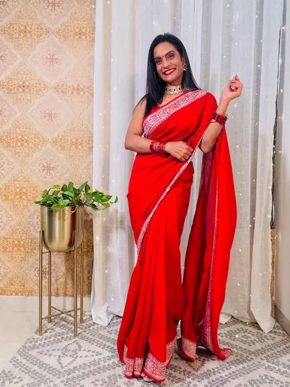 Another beautiful red saree, this one with a slightly broader, more detailed border. It's a very festive and traditional choice.