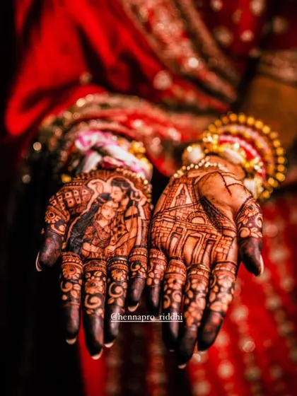 A dramatic and beautiful shot of a portrait henna stain. The deep, rich color makes the depiction of Shiv and Parvati alongside the Kedarnath temple stand out even more.