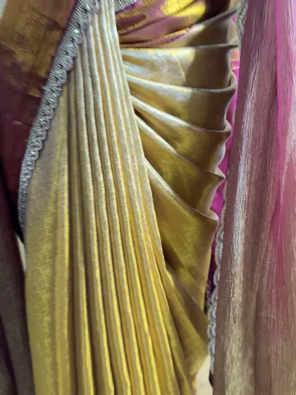 A macro shot of the mermaid hip pleats. This technique helps shape the saree beautifully around the hips, often without needing shapewear.