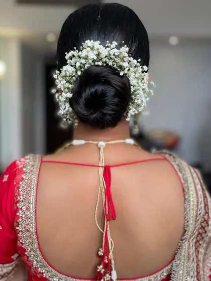 A clean and soft twisted bun, perfect for the minimalist bride. I added a simple arch of baby's breath for a touch of classic bridal elegance.