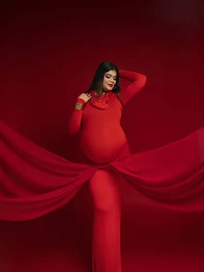 Wrapped in elegance. This pose, with the fabric gracefully encircling the bump, creates a beautiful focal point and adds a layer of artistic texture to the portrait. It's a celebration of the life you are creating.
