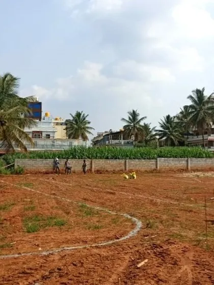 Our team on-site, carefully reviewing plans to ensure the successful execution of a sports facility project for a school.