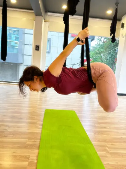 A gentle forward fold in the hammock, perfect for releasing tension in the back and shoulders.