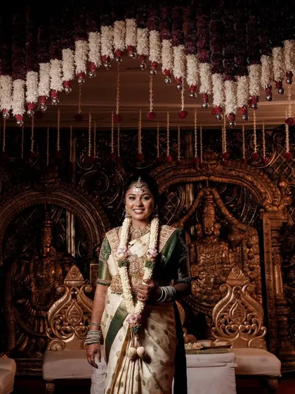 Pavani on her wedding stage, looking radiant under the lights. The HD makeup ensures she doesn't look washed out and her features are beautifully defined.