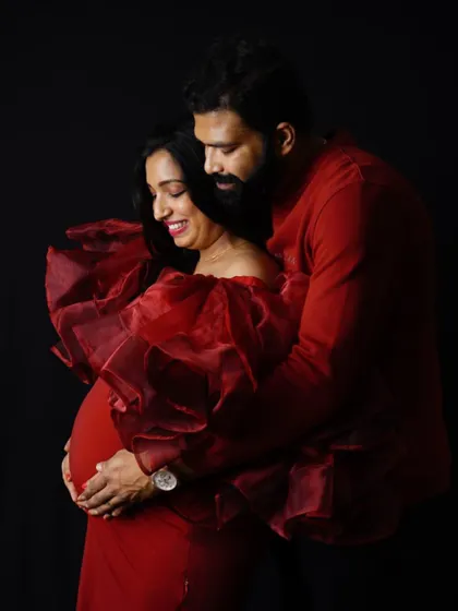 An intimate couple's portrait in our red Ruth gown. The rich organza fabric and deep red color create a warm and romantic mood.