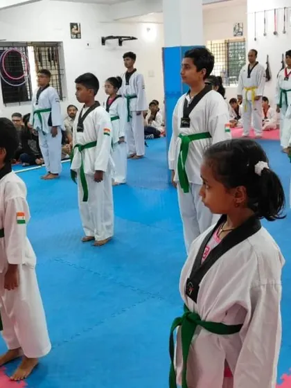 A line of green belts, standing at attention.