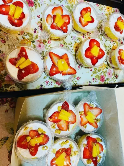 Boxes of my delicious fruit trifle cups, beautifully topped with fresh strawberries and mango. They are a refreshing and yummy treat.
