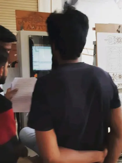 Students review a cutting list and program on paper before executing the job on the CNC machine, emphasizing the importance of planning in digital woodworking.