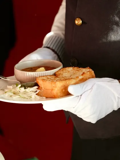 A server presents a plate of classic Pav Bhaji at the Sampoorn Ramayana event. We believe in offering beloved comfort foods, executed with the highest quality ingredients and professional service.