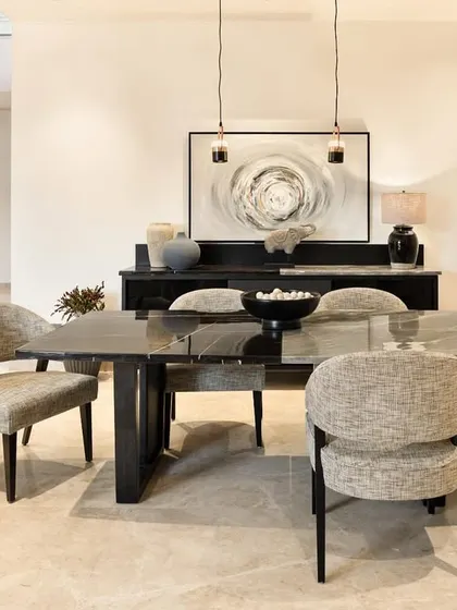The first-floor dining area is designed for family gatherings. The custom-made dining table and chairs, crafted in our workshop, are surrounded by natural light and views of the neighborhood, creating an inviting atmosphere for everyday rituals.
