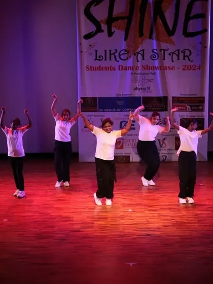 The entire group with their hands up, feeling the music.