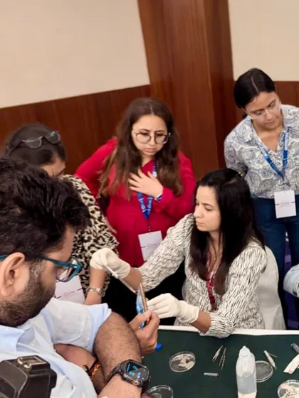 Here I am demonstrating a hands-on procedural technique during a Vitiligo workshop for other dermatologists. I believe that sharing knowledge is key to advancing our field, and I am passionate about teaching the practical skills required for successful Vitiligo surgery, including suspension preparation and grafting.