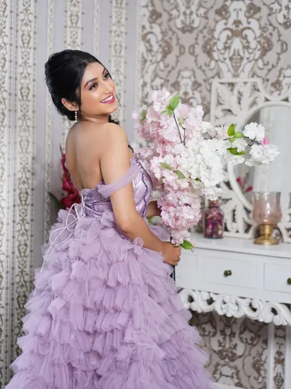 A lovely portrait capturing a happy expression, with the model holding a large bouquet of flowers.