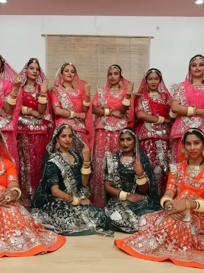 A group of performers in stunning, colorful Rajasthani costumes. Coordinating outfits is a key part of creating a visually spectacular group dance.