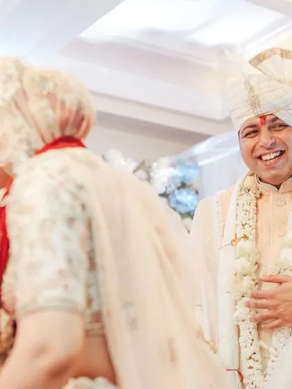 The groom's joyful reaction as he sees his bride, a priceless, unscripted moment.