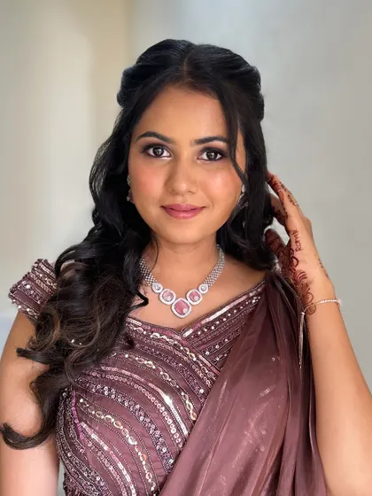 A beautiful client ready for a party. Her makeup is soft and glamorous, with a focus on her eyes.