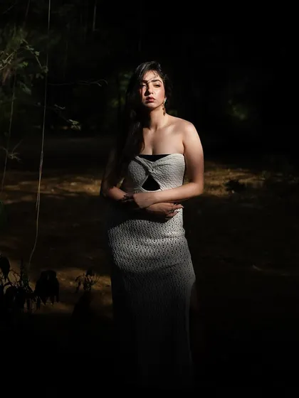A full-length shot in the forest, surrounded by darkness but highlighted by a single beam of light. A very moody and powerful image.
