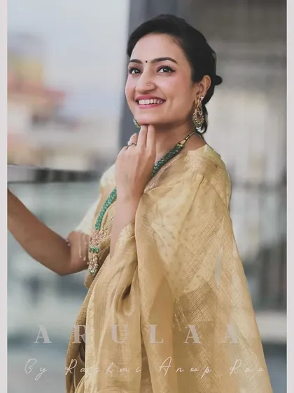 Another beautiful saree look for Vaishnavi. This beige tussar silk saree is paired with a simple boat-neck blouse I designed, accessorized with a stunning emerald necklace.