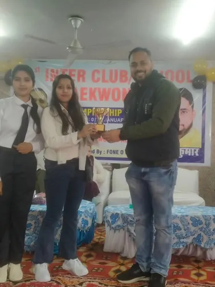 Receiving an award for the academy's performance at the Inter-Club championship. Our team's collective effort is always recognized.