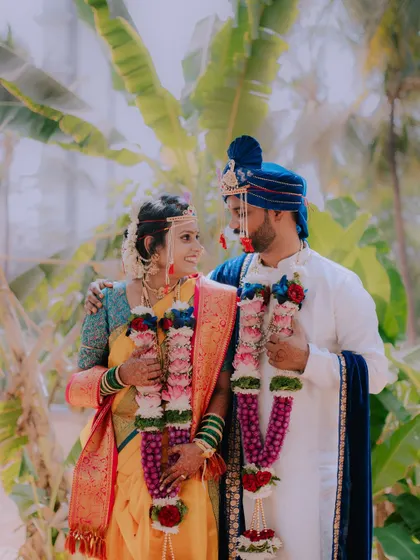A beautiful portrait of a newly married couple in their traditional Maharashtrian wedding attire.