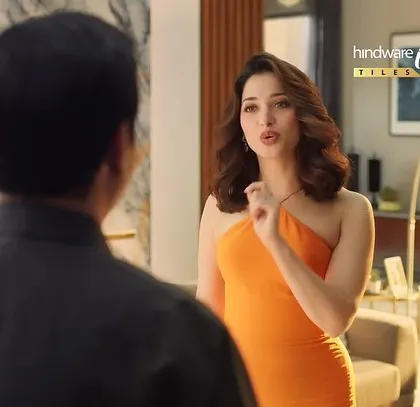 Another shot of Tamannaah from the Hindware ad, capturing her conversation with the homeowner. Her elegant dress elevates the scene.