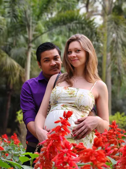 Posing with my husband during our pregnancy photoshoot. Sharing this journey with a supportive partner makes all the difference.