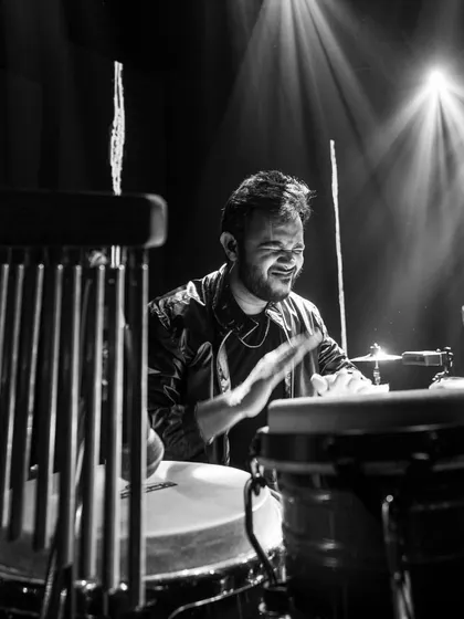 Another powerful black and white shot from a concert in Raipur. The focus and energy are palpable as I play the congas, surrounded by my percussion kit.