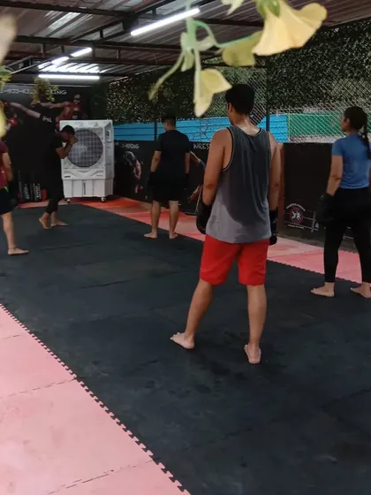 Members spread out on the mats during a training session at our open-air Sector 141 facility, showcasing the space and community atmosphere.