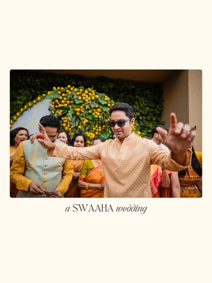 The joy of the celebration is infectious, as a guest dances against a backdrop of yellow flowers.